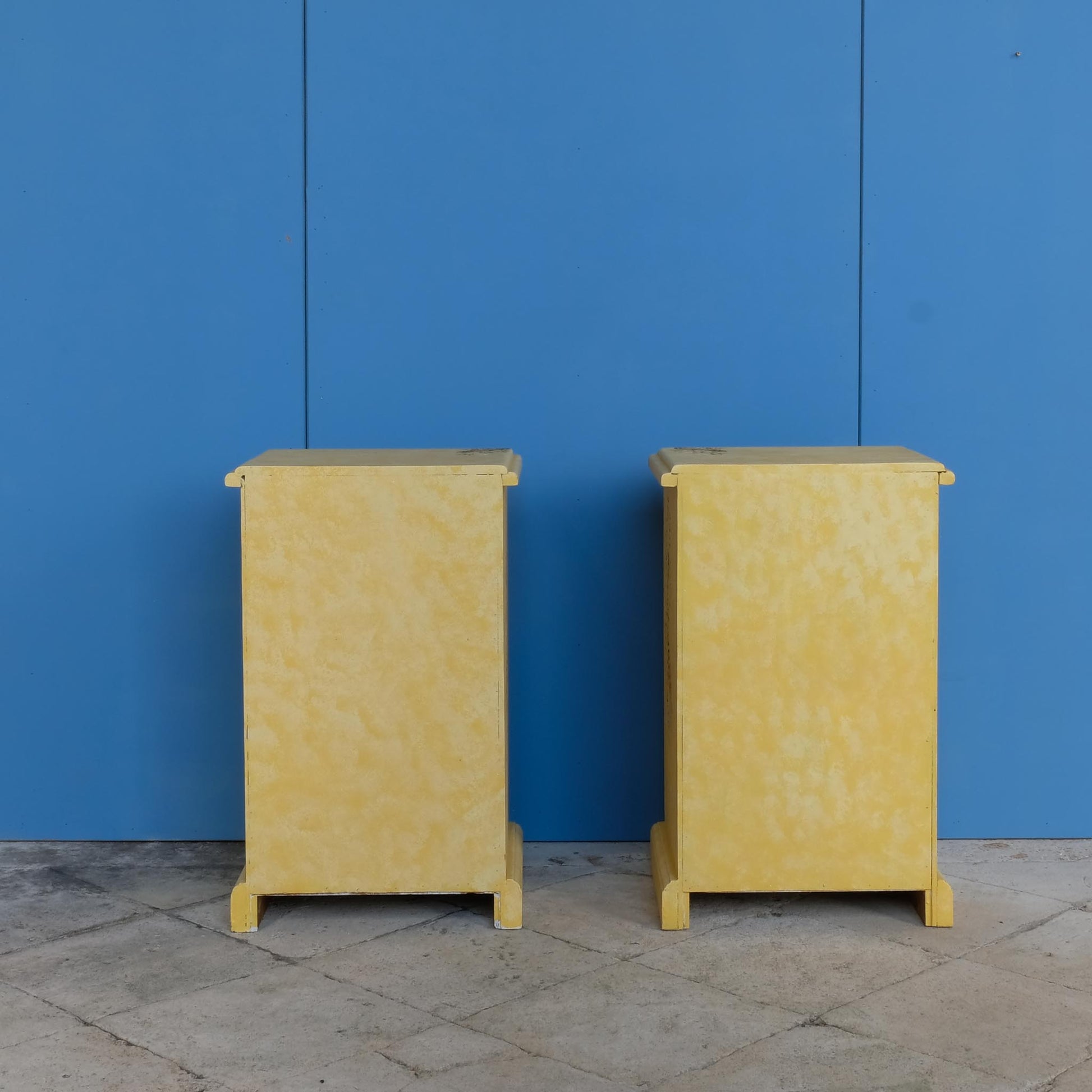 A stunning, unique matching pair of hand-painted chests of drawers, with brushing slides over three drawers. Finished in a fetching patinated yellow and decorated with exotic animals and Flora, in very good condition. Ideal for a children's bedroom or to liven up a sitting room. A unique pair in collaboration with Bunny Howe.