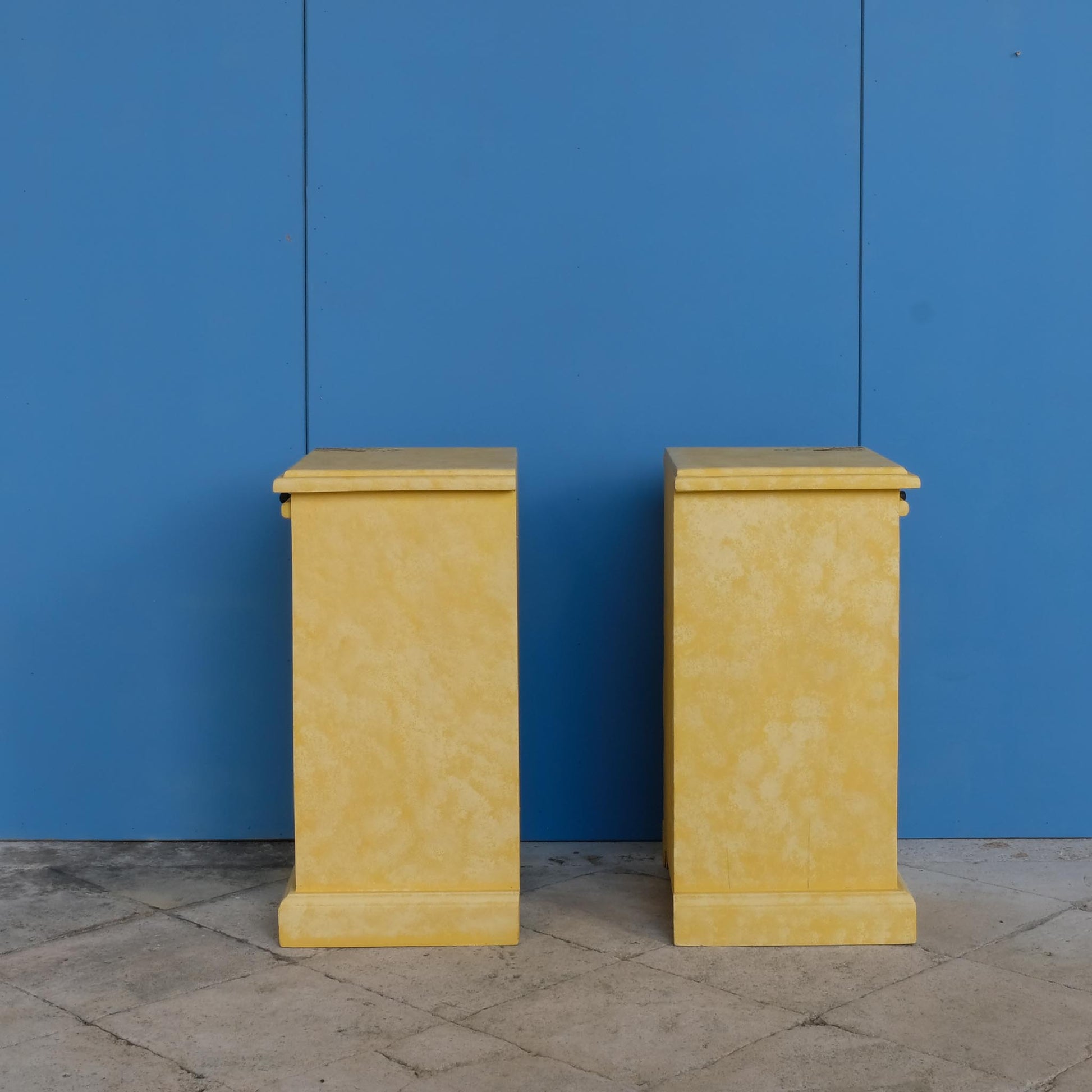 A stunning, unique matching pair of hand-painted chests of drawers, with brushing slides over three drawers. Finished in a fetching patinated yellow and decorated with exotic animals and Flora, in very good condition. Ideal for a children's bedroom or to liven up a sitting room. A unique pair in collaboration with Bunny Howe.