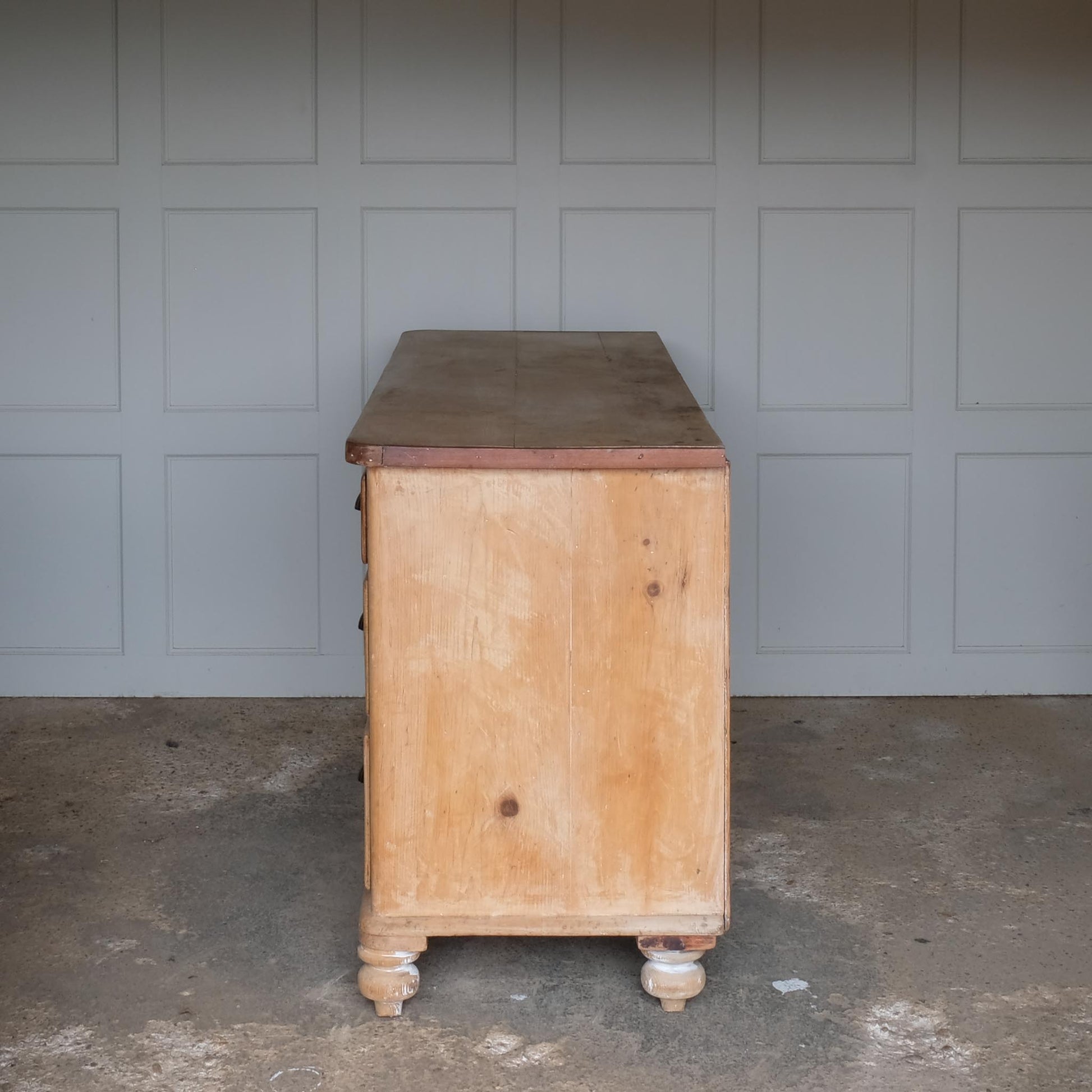 A large oak sideboard with, presumably late 19th / early 20th Century, comprising three drawers on each side with scallop cup handles, and a central drawer over a hinged cupboard door, raised on four turned bun feet. In very good, solid condition. Perfect for a kitchen or entrance hallway.