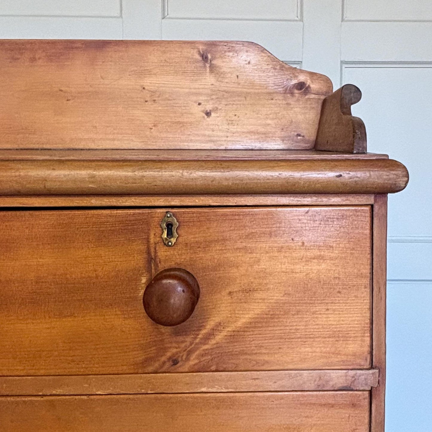 An Edwardian pine chest of drawers with 3/4 galleried top, with two short over two long drawers, raised on turned bun feet. Some gentle patina as to be expected, the drawers all working smoothly, in very good condition.