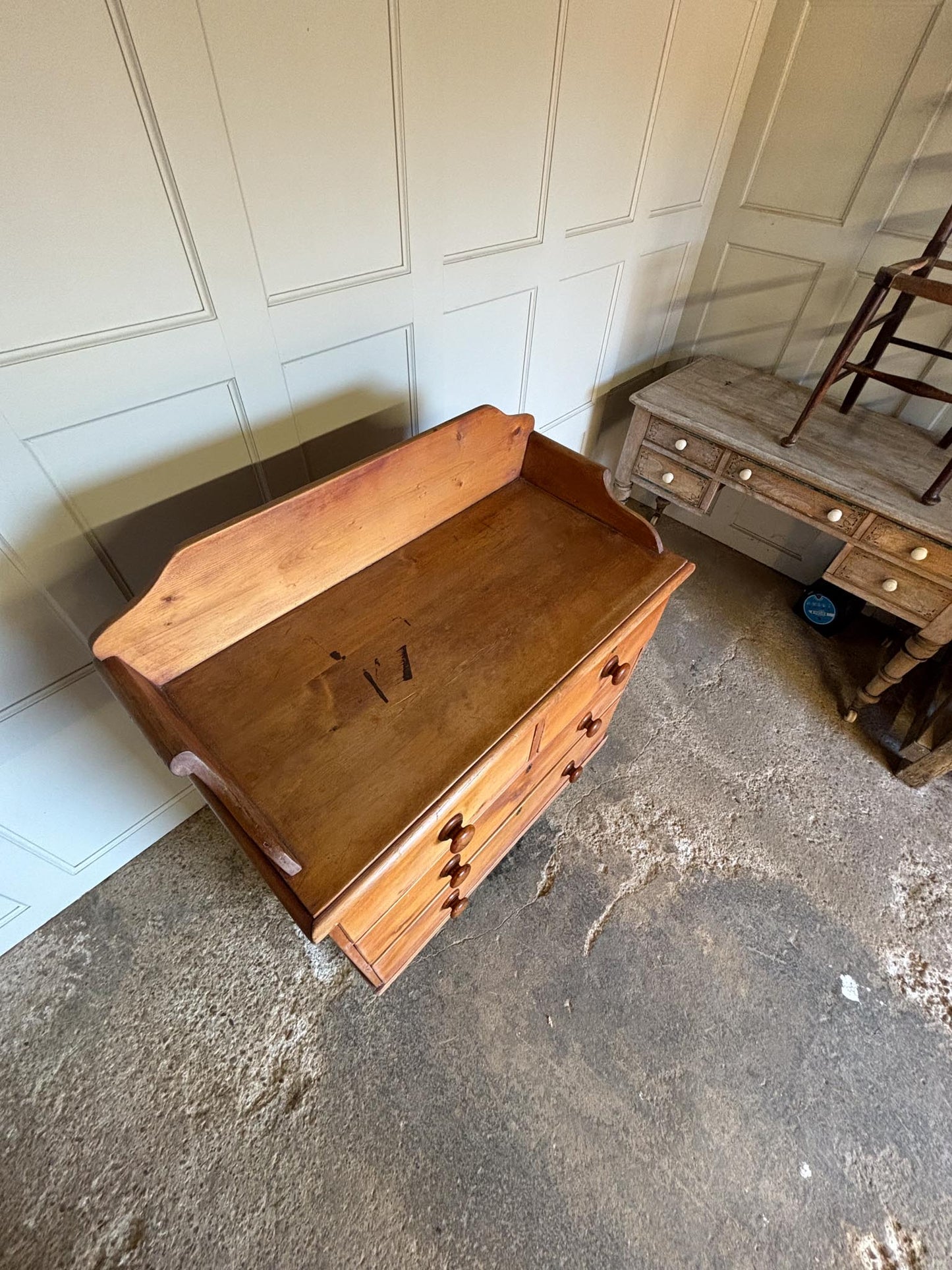 An Edwardian pine chest of drawers with 3/4 galleried top, with two short over two long drawers, raised on turned bun feet. Some gentle patina as to be expected, the drawers all working smoothly, in very good condition.